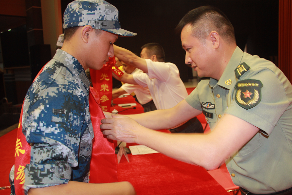 区人武部领导给入伍新兵带大红花.JPG